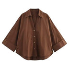 Brown button-up shirt on a white background