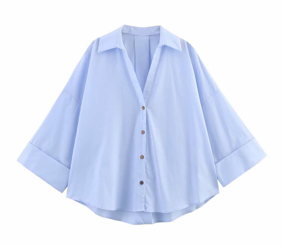 Light blue shirt with rolled-up sleeves on a white background