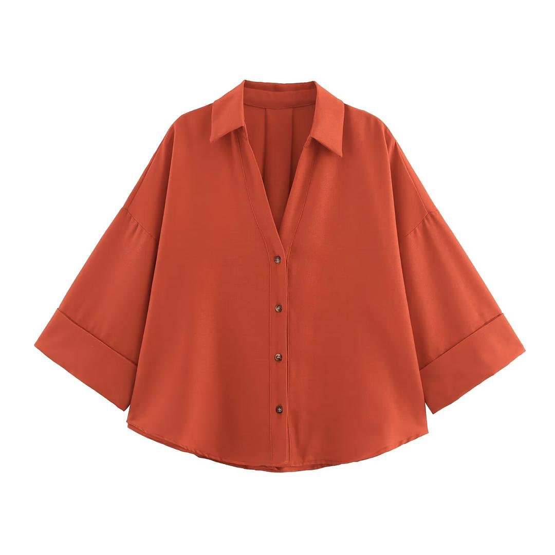 Orange button-up shirt on a white background