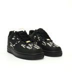 Black sneakers with white floral patterns on a white background