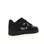 Black sneaker with white pattern on a white background