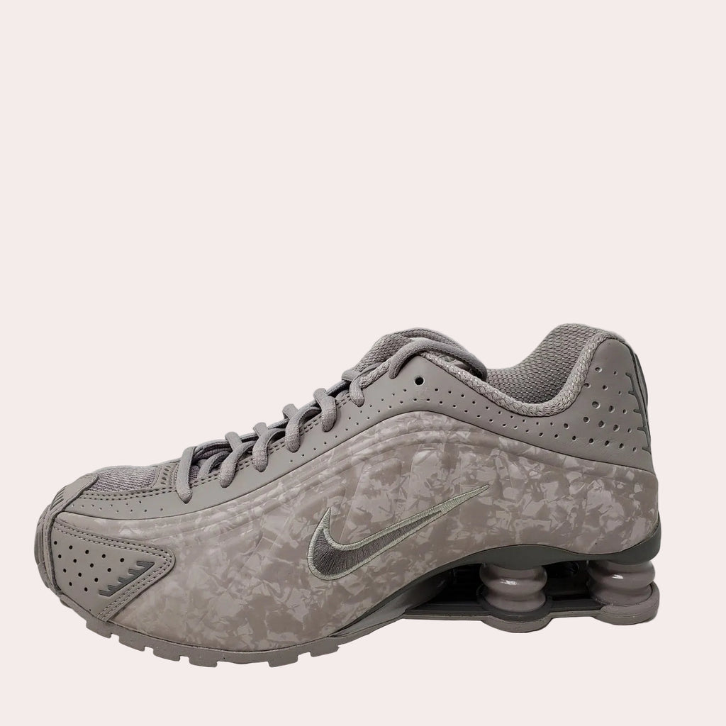 Gray sneaker with Nike logo on a light gray background