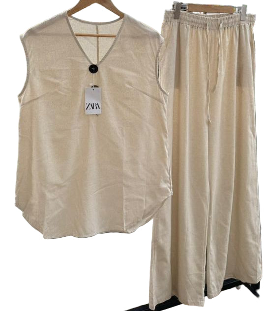 Beige sleeveless top and pants set with a Zara tag on a white background