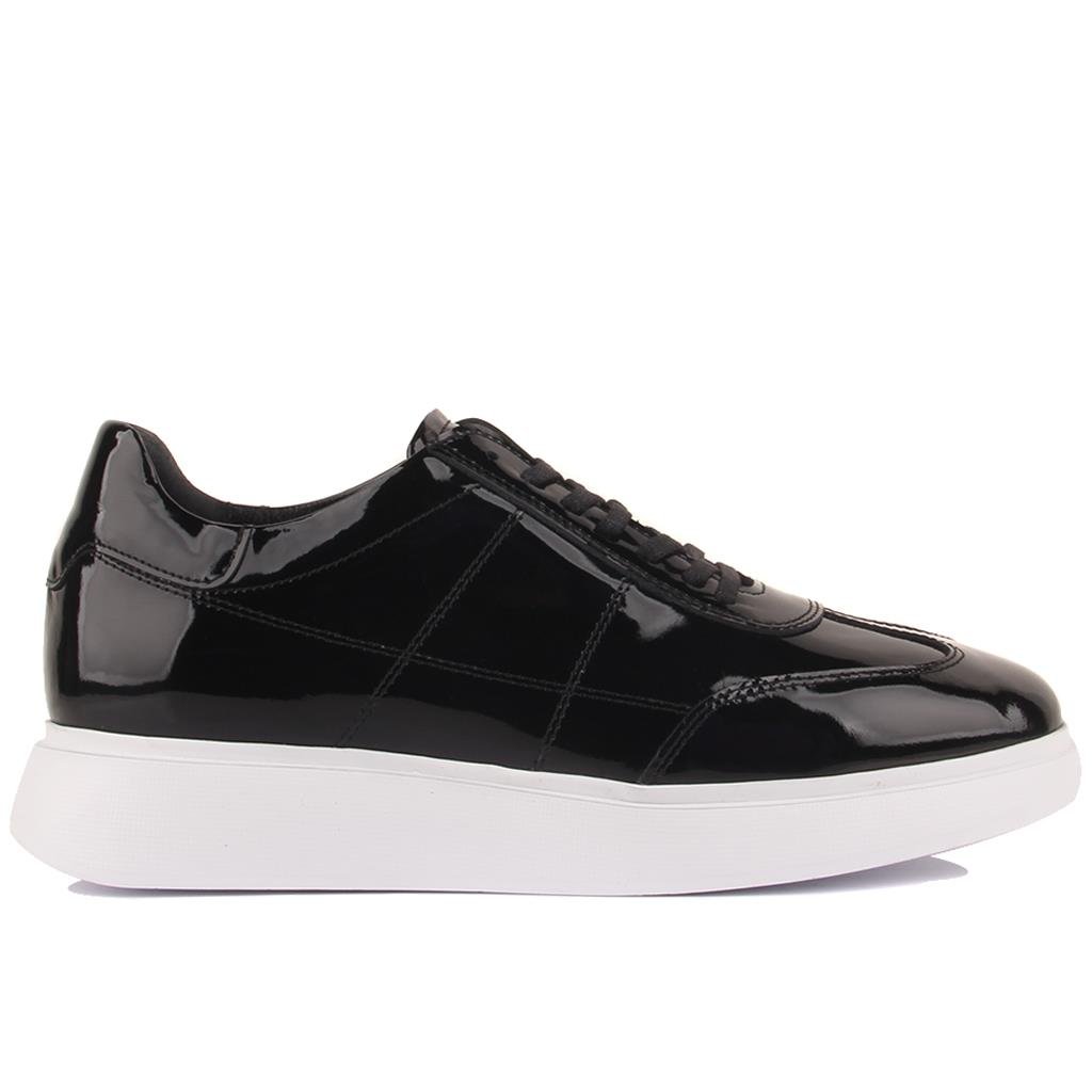 Black patent leather sneaker on a white background