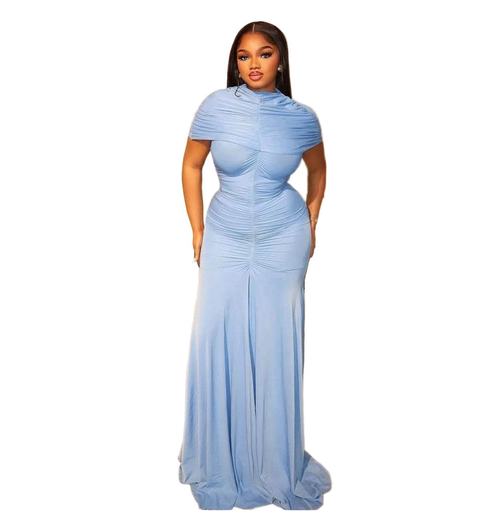 Woman in a blue evening gown standing in an elegant indoor setting.