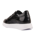 Black patent leather sneaker with a white sole on a white background