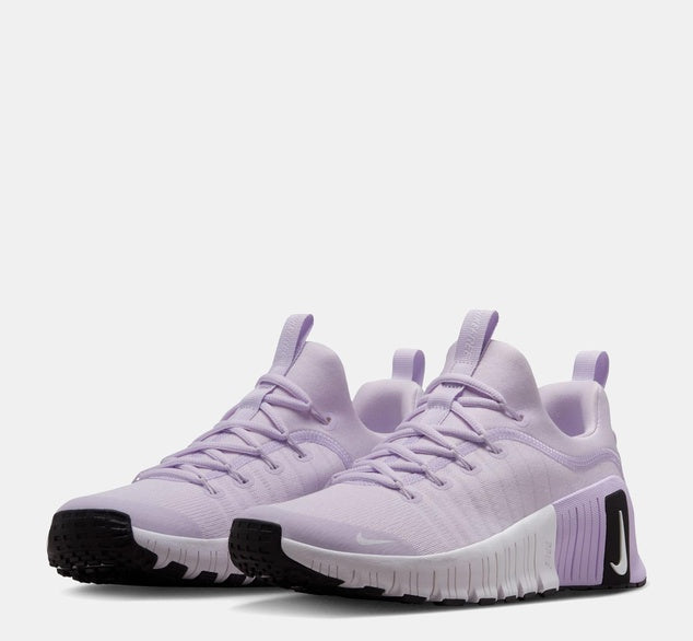 Pair of light purple sneakers with black soles on a white background