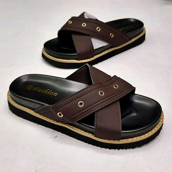 Pair of brown sandals with black soles on a white background