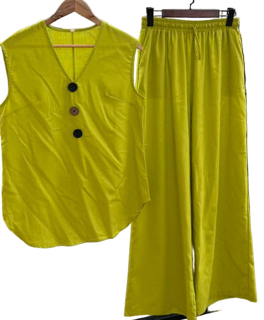 Yellow sleeveless top and wide-leg pants on hangers against a white background