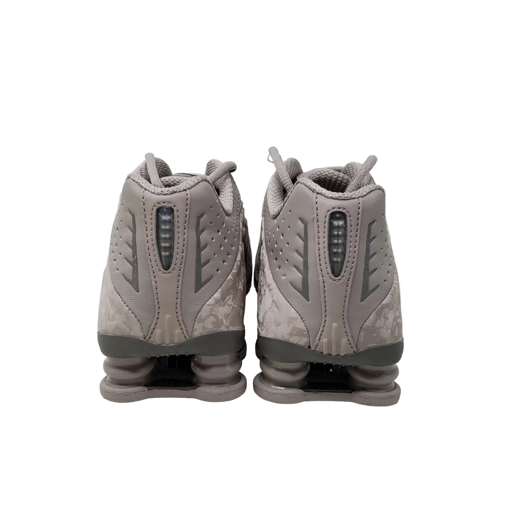 Pair of gray athletic shoes on a light gray background