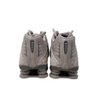 Pair of gray athletic shoes on a light gray background