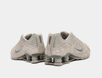 Pair of gray Nike sneakers on a white background