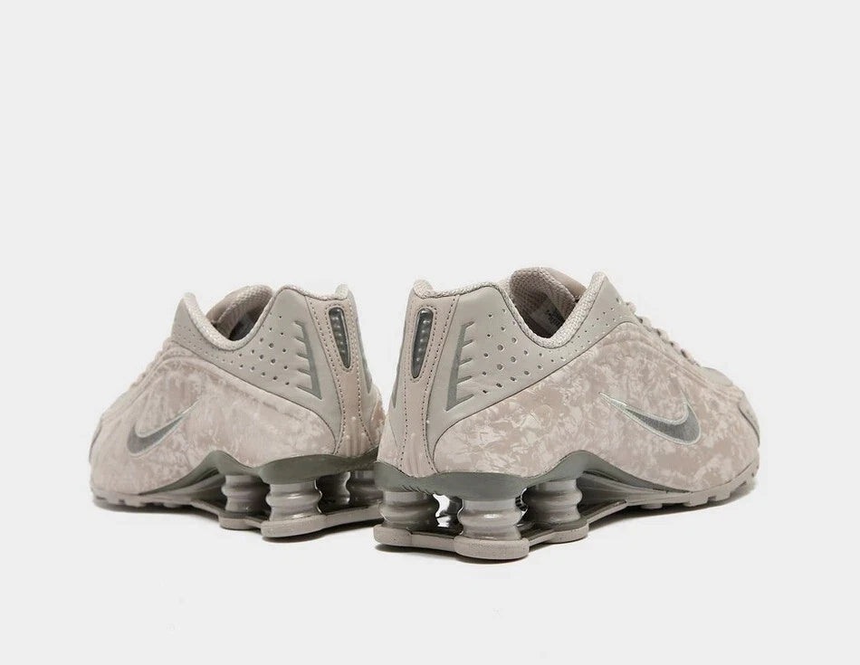Pair of gray Nike sneakers on a white background